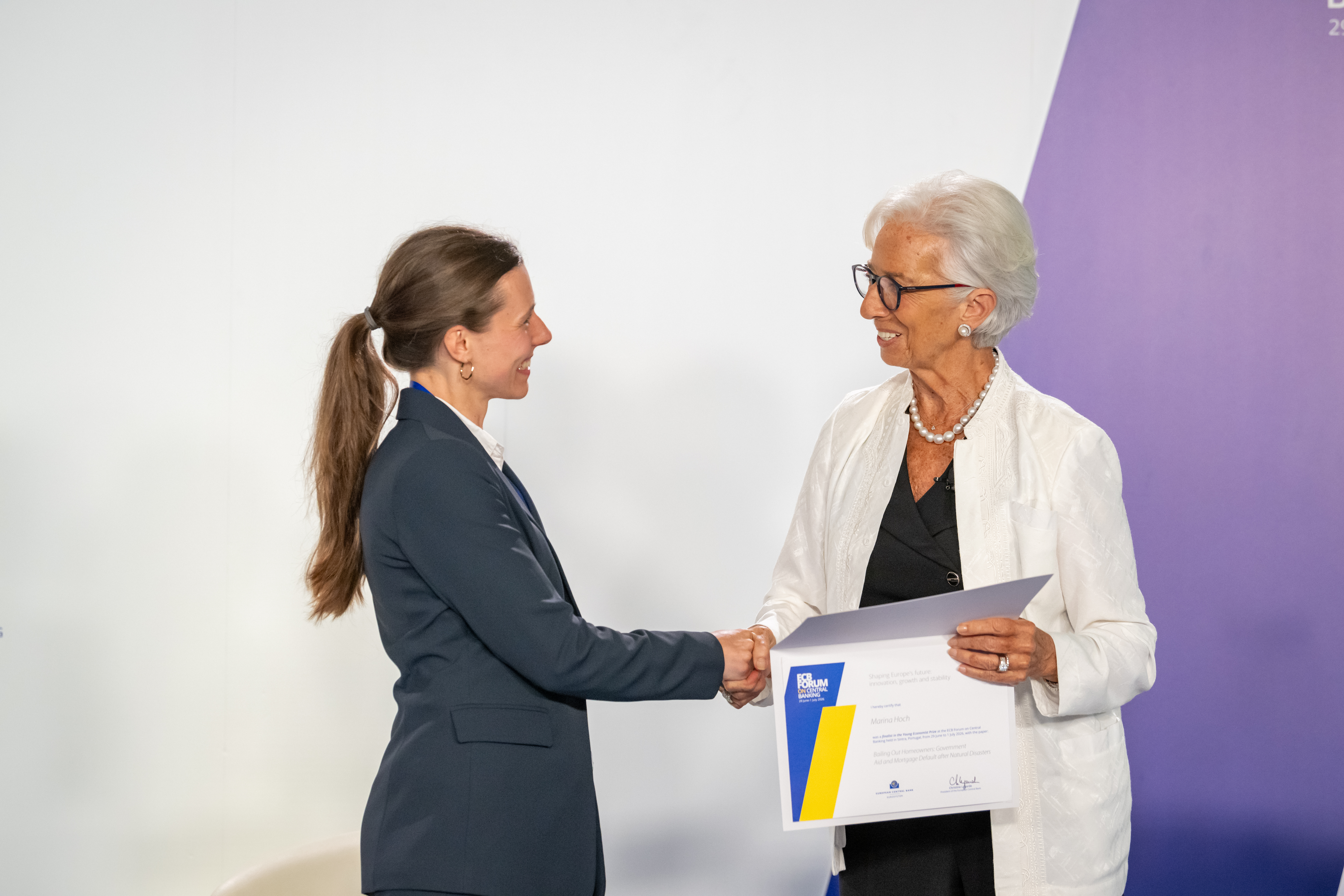 ECB president Christine Lagarde hands certificate to Marina Hoch.