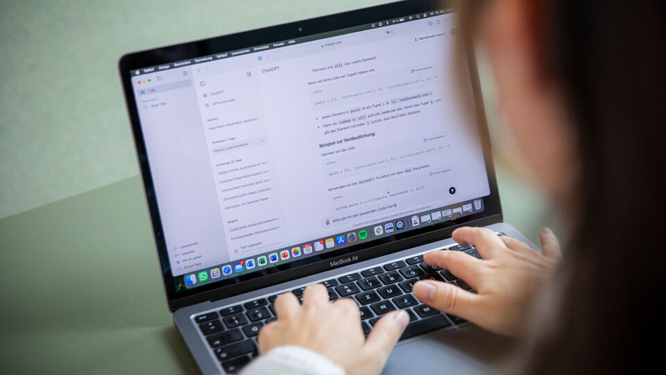 Hands typing on a laptop.