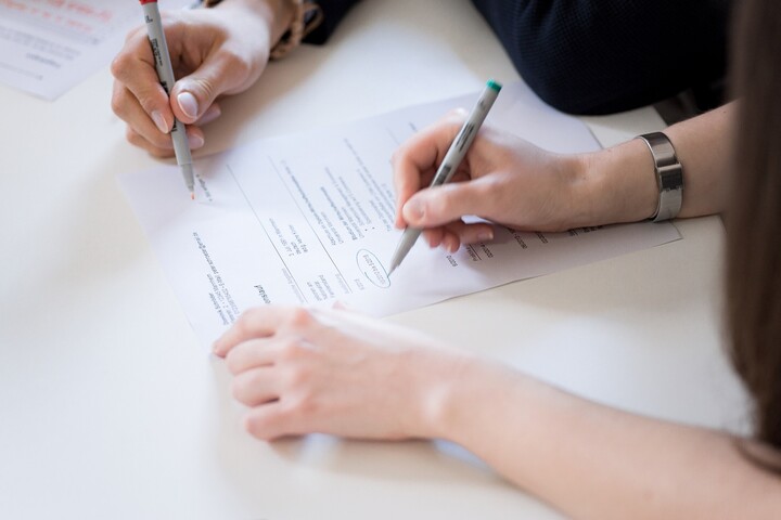 Hands writing on document