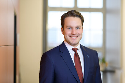 Prof. Glenk hat kurze Haare und trägt Anzug und Krawatte.