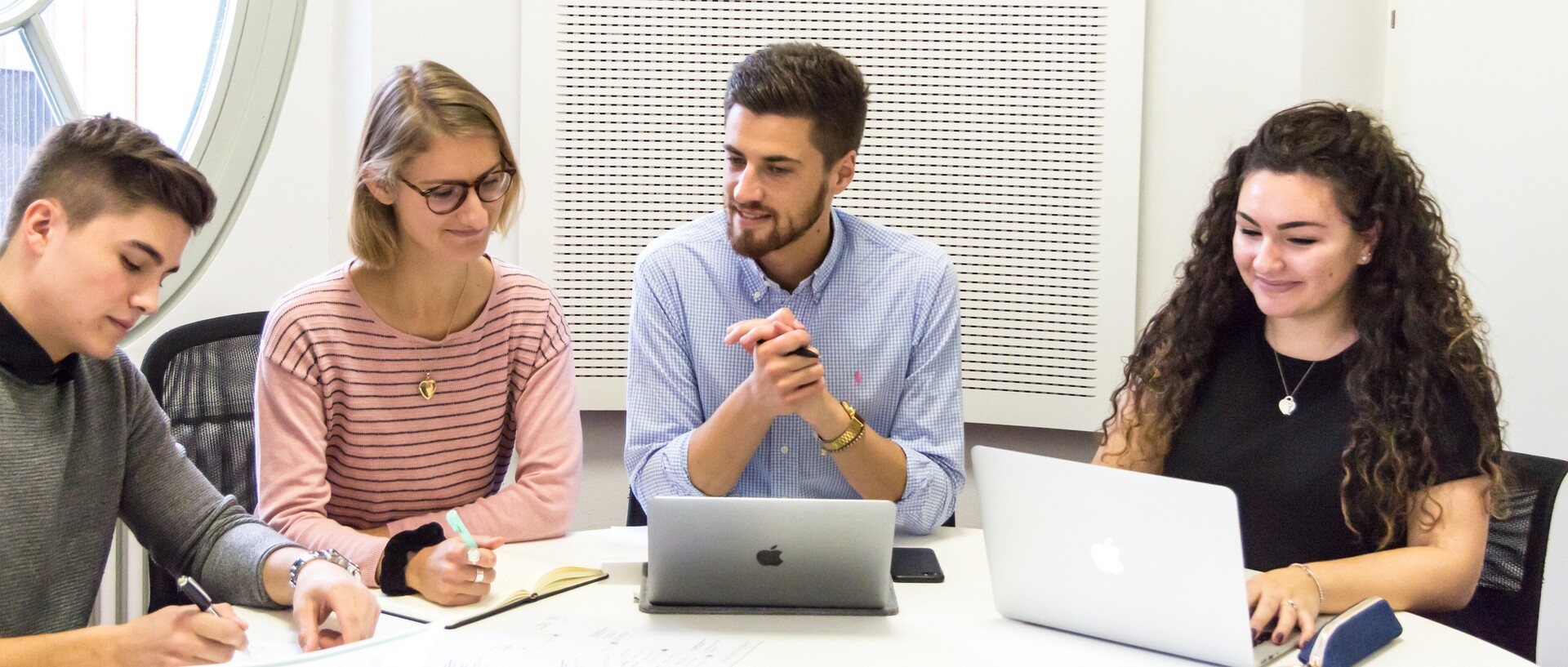 Students with laptops at the table