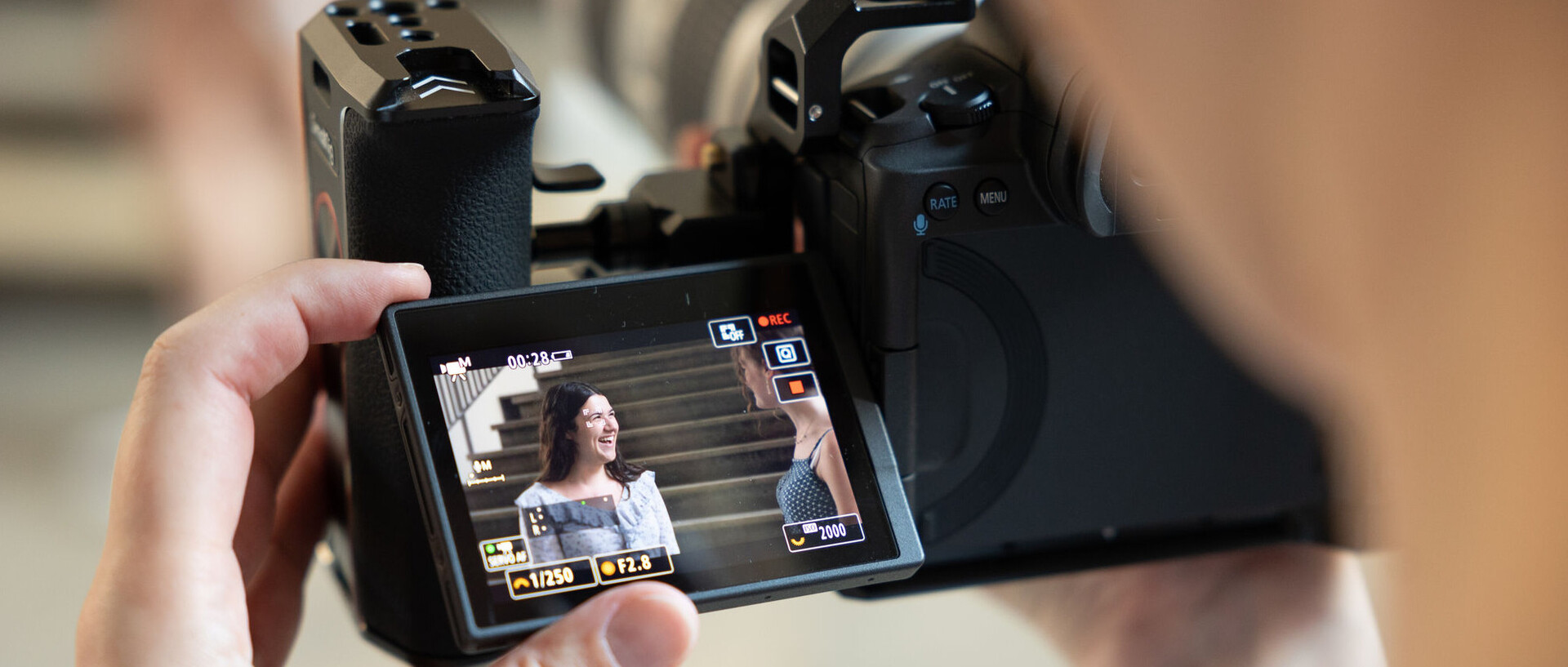 camera with a picture of two smiling students on the display