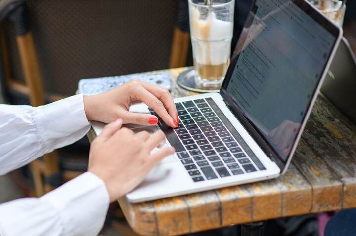 Picture of hands with laptop and lettering: Business School newsletter for current students, prospective students and alumni