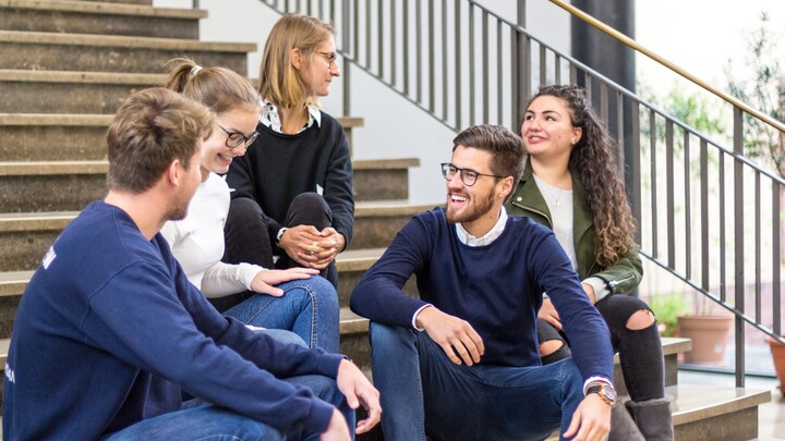 Group of students sitting on stairs