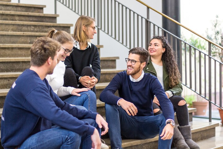 Group of students sitting on stairs