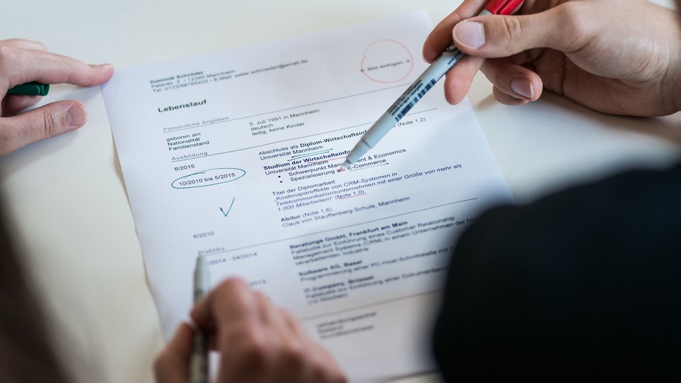Hands with pens on document